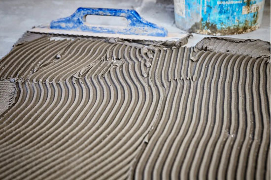 tile adhesive applied to surface